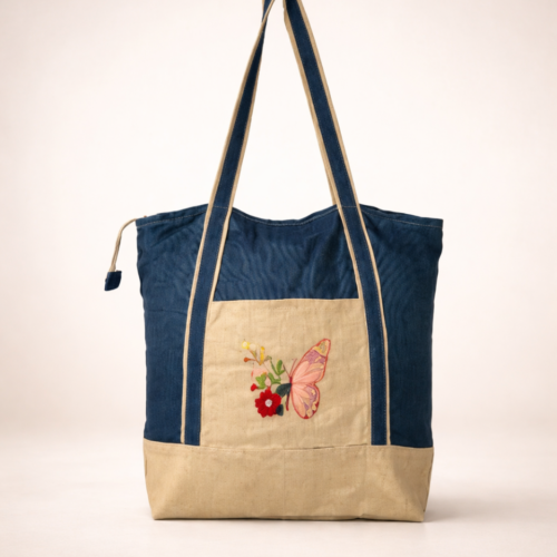 Hand embroidered tote bag with butterfly floral design in cotton fabric